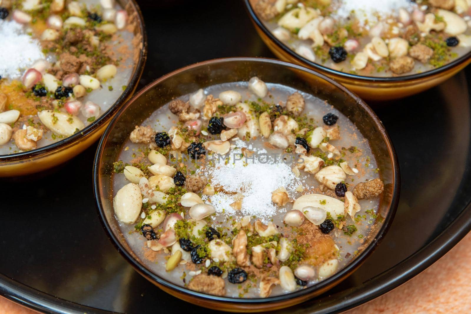 Traditional Turkish Dessert is Asure "Noah's Pudding" on wooden background