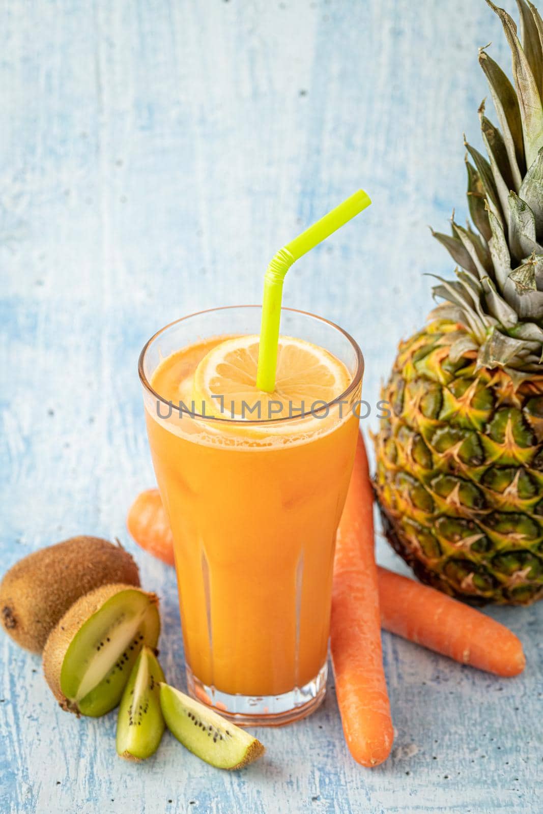 Refreshing and energizing orange juice with kiwi, pineapple and carrots