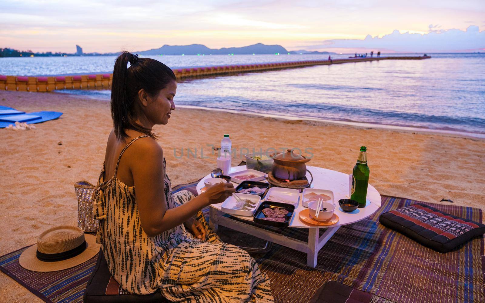 women bbq cooking noodle soup on the beach in Pattaya during sunset in Thailand Ban Amphur beach by fokkebok