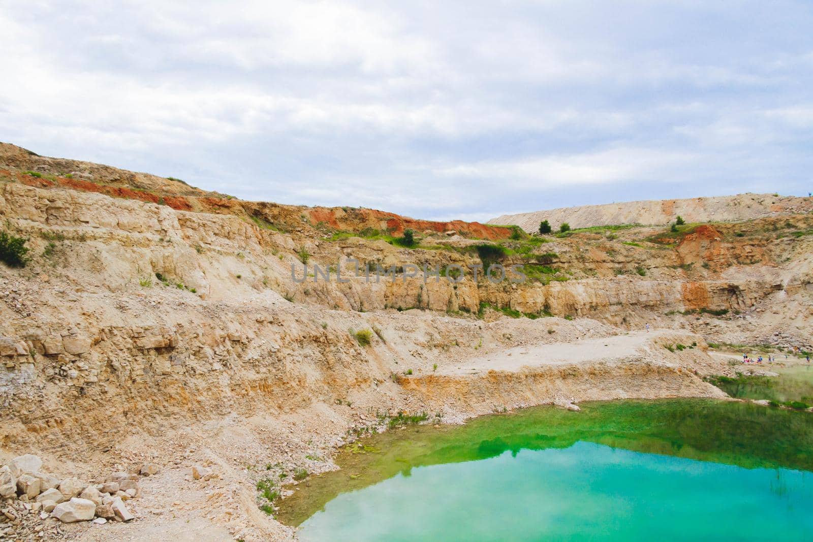 Lake formation in an old abandoned quarry. Quarry lake. Crushed stone dumps in a closed area for stone extraction. Termination of mining operations.