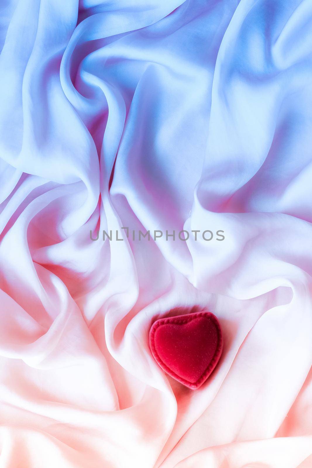 Heart-shaped gift box on neon silk by Anneleven