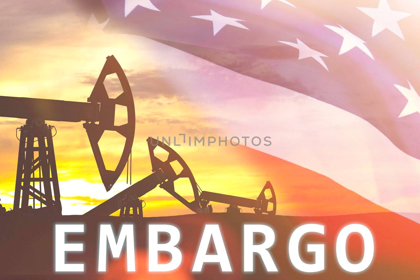 US oil embargo. The ban on the import of oil into the country. Supply restriction. Oil rigs at sunset.