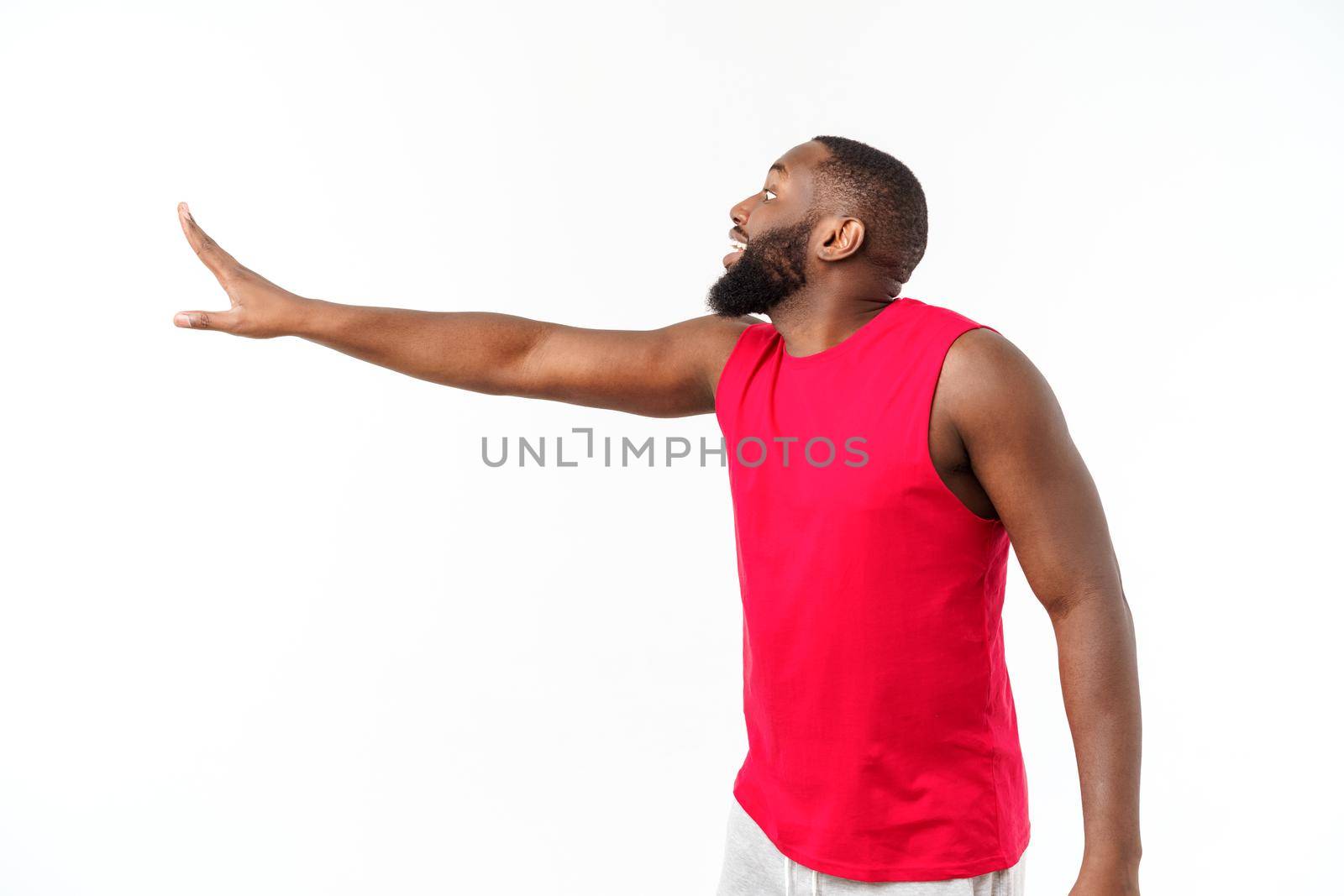 Young sport african american man extending hands to the side for inviting to come by Benzoix