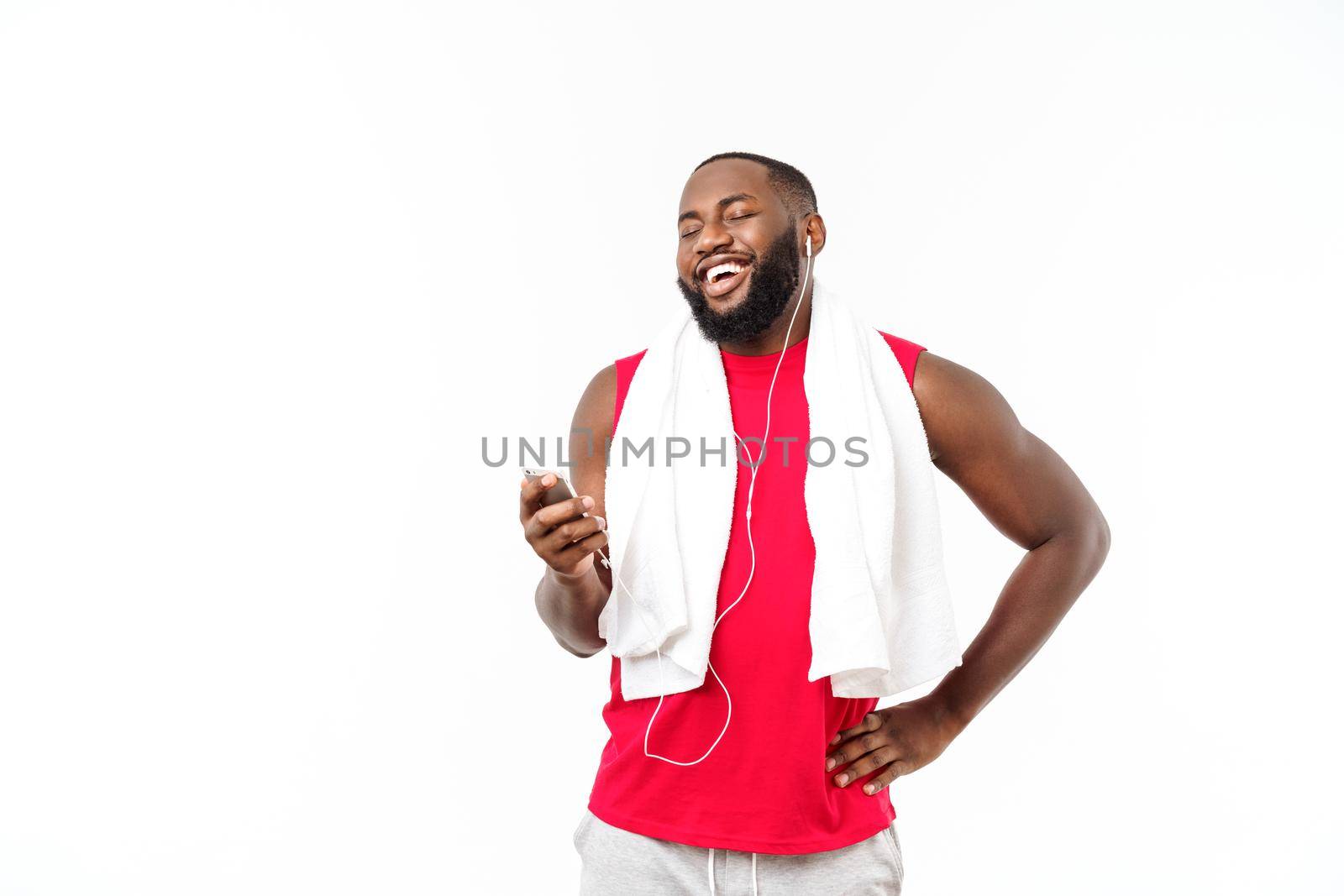 Handsome African American man listening music on his mobile device after sport exercise
