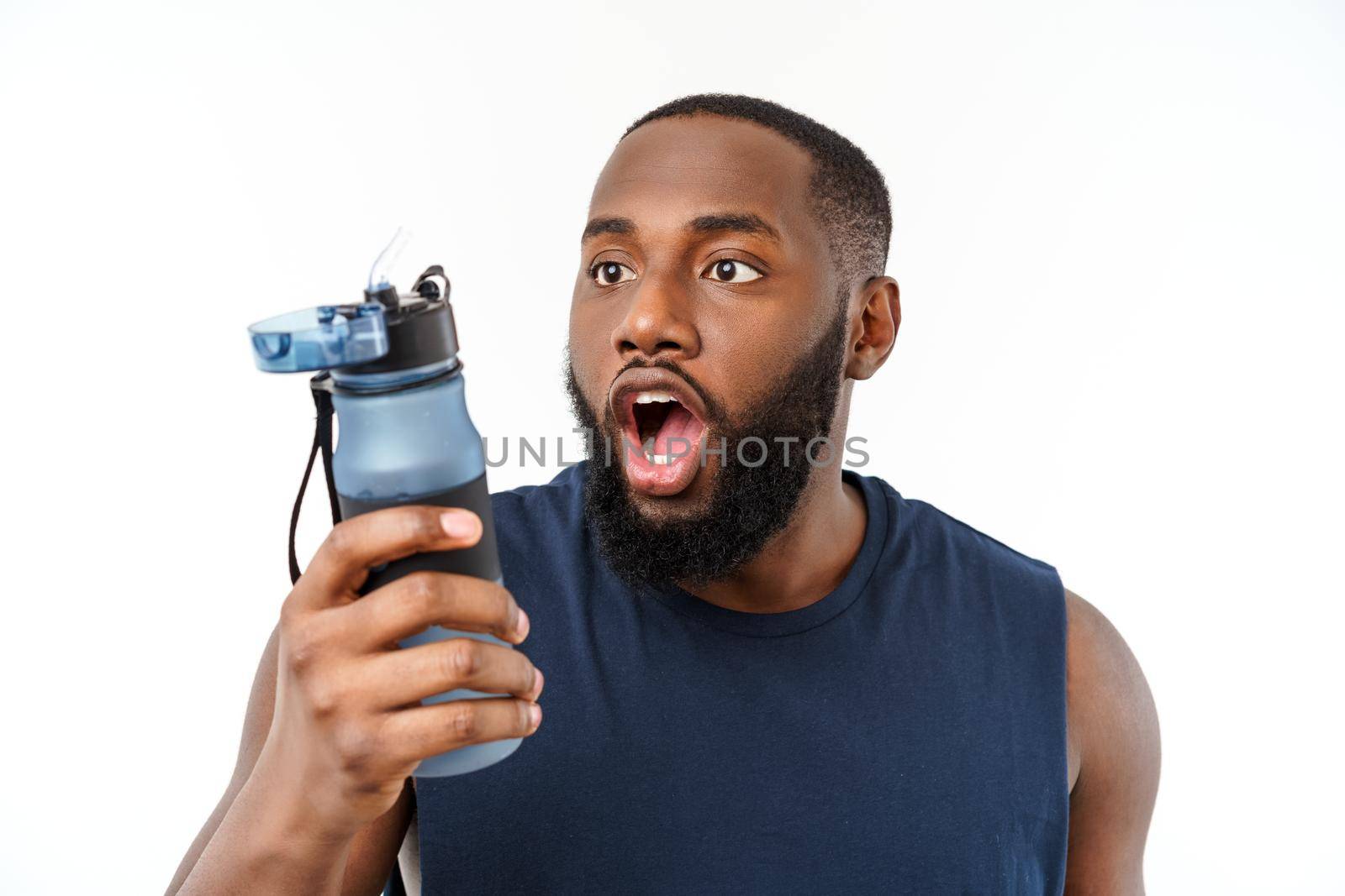 Young muscular build man hold bottle water after running, attractive athlete resting after workout outdoors, fitness and healthy lifestyle concept. Isolated on white