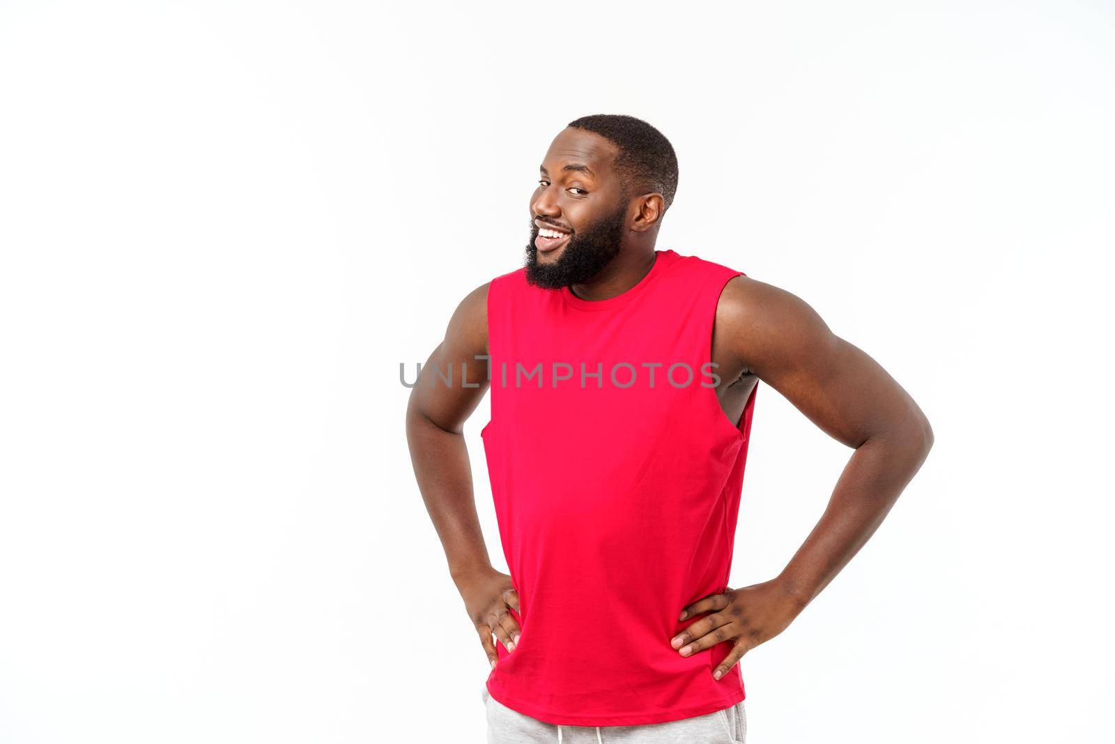 African American teenager shows muscles on arm. Isolated on white background. Studio portrait. Transitional age concept by Benzoix