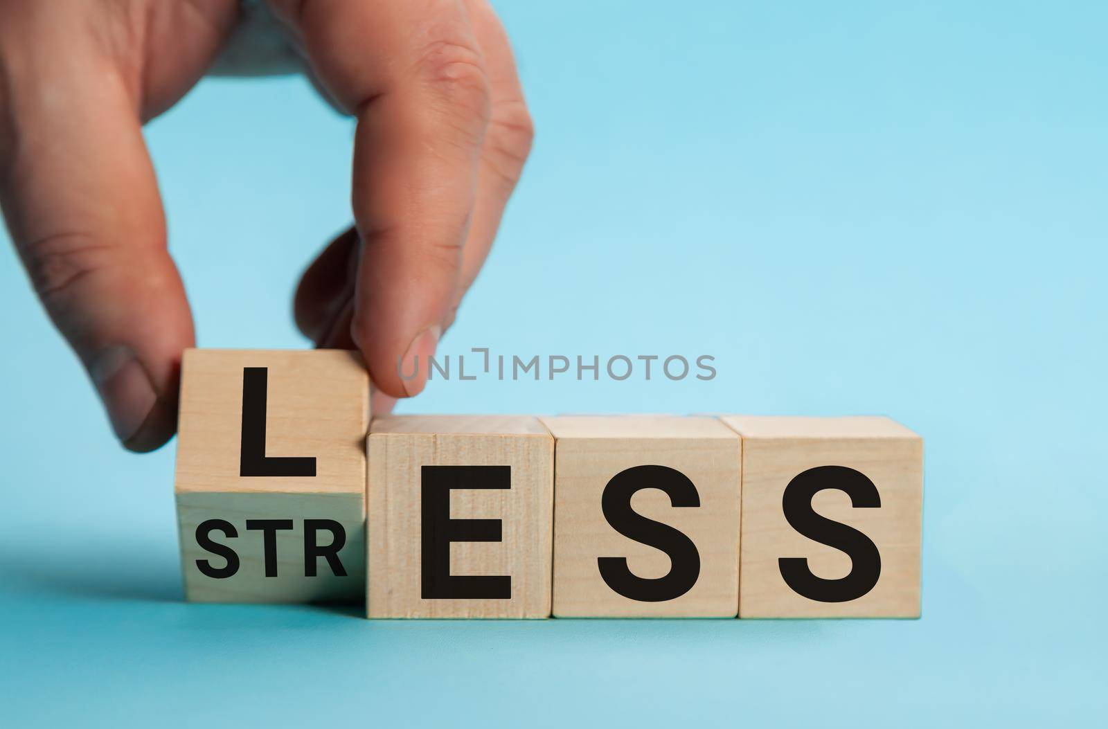 Having less stress or being stress-less. The word on wooden cubes. The concept of having less stress or being stress-less in letters. Business and psychological.
