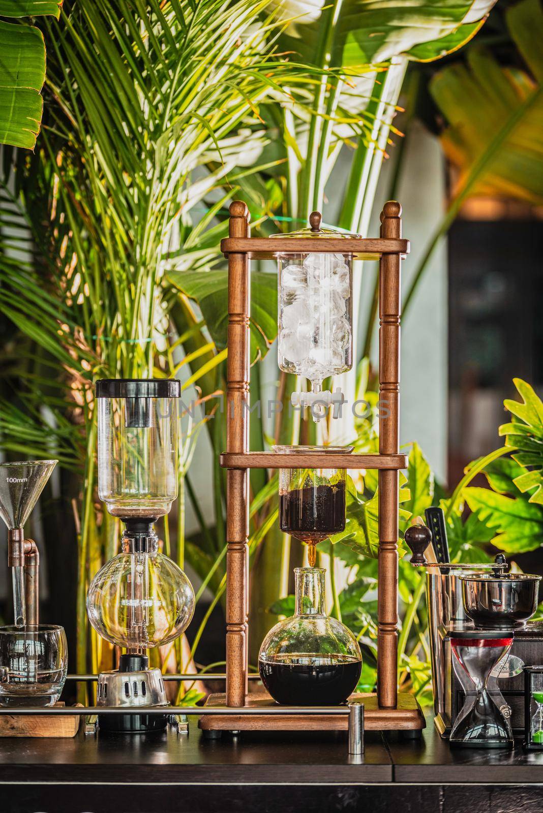 cold drip coffee tower with soft-focus and over light in the background by Sonat