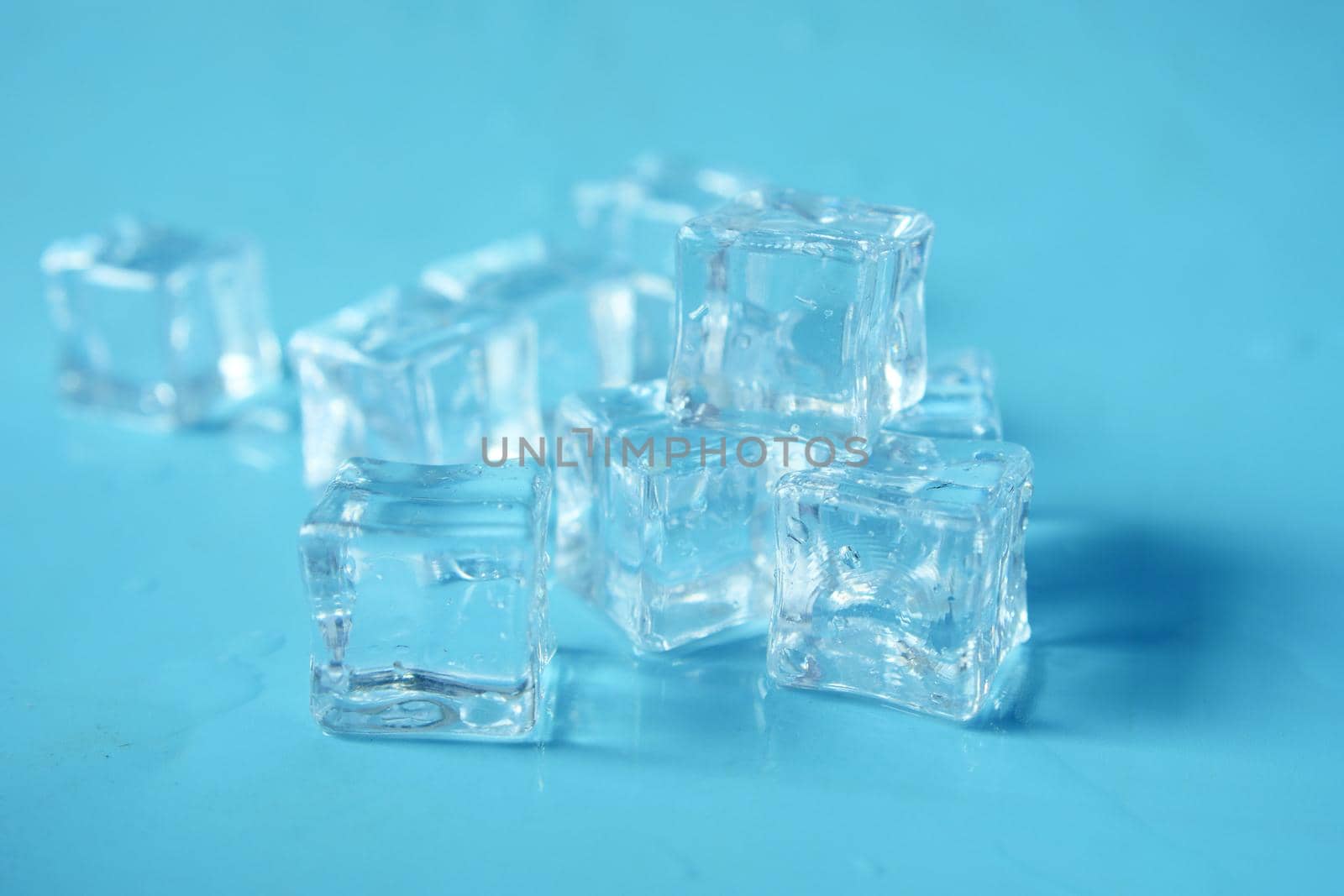 close up of many ice cubes on white background .