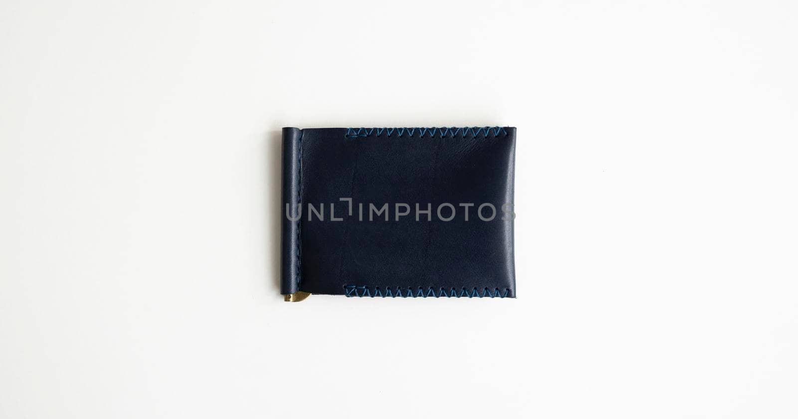 Blue money clip handmade from genuine leather on white surface