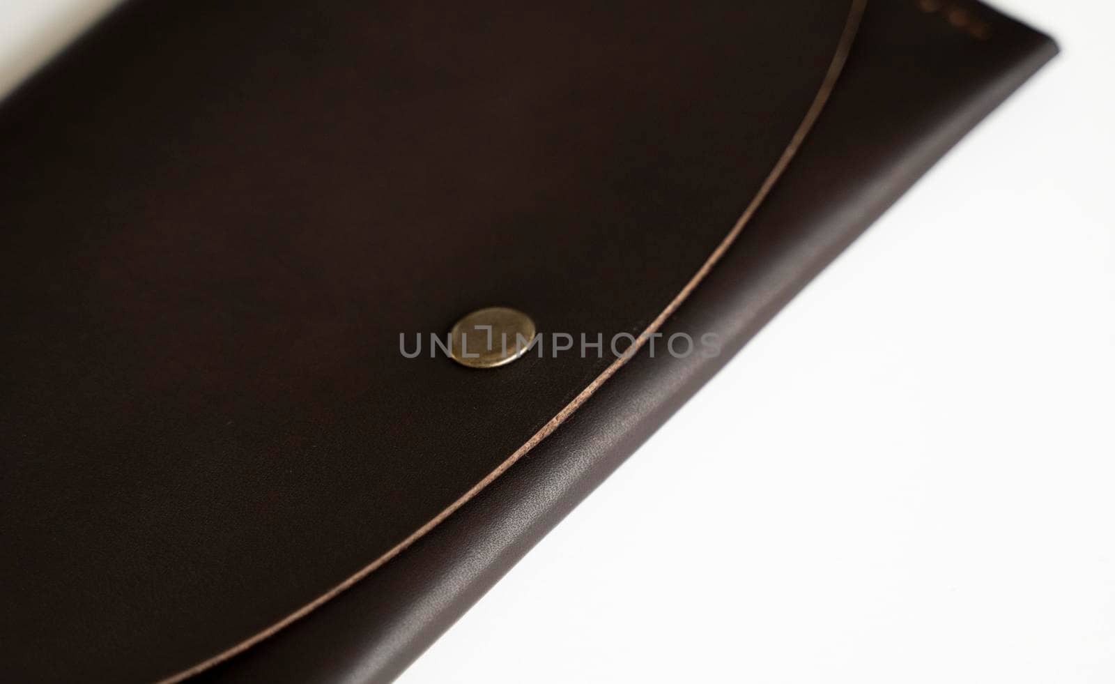 Man's brown natural genuine leather wallet isolated on white background. Expensive man's purse closeup