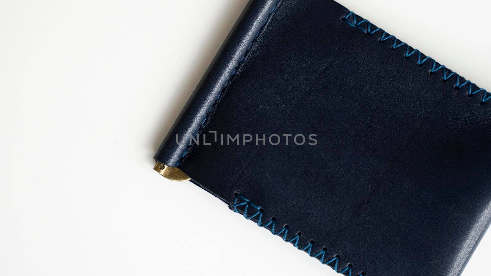 Blue money clip handmade from genuine leather on white surface