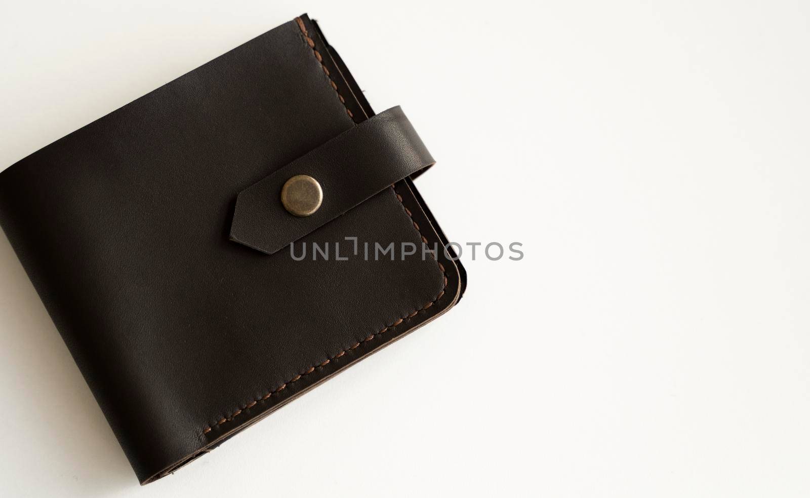 Brown natural genuine leather wallet isolated on white background. Expensive man's purse closeup