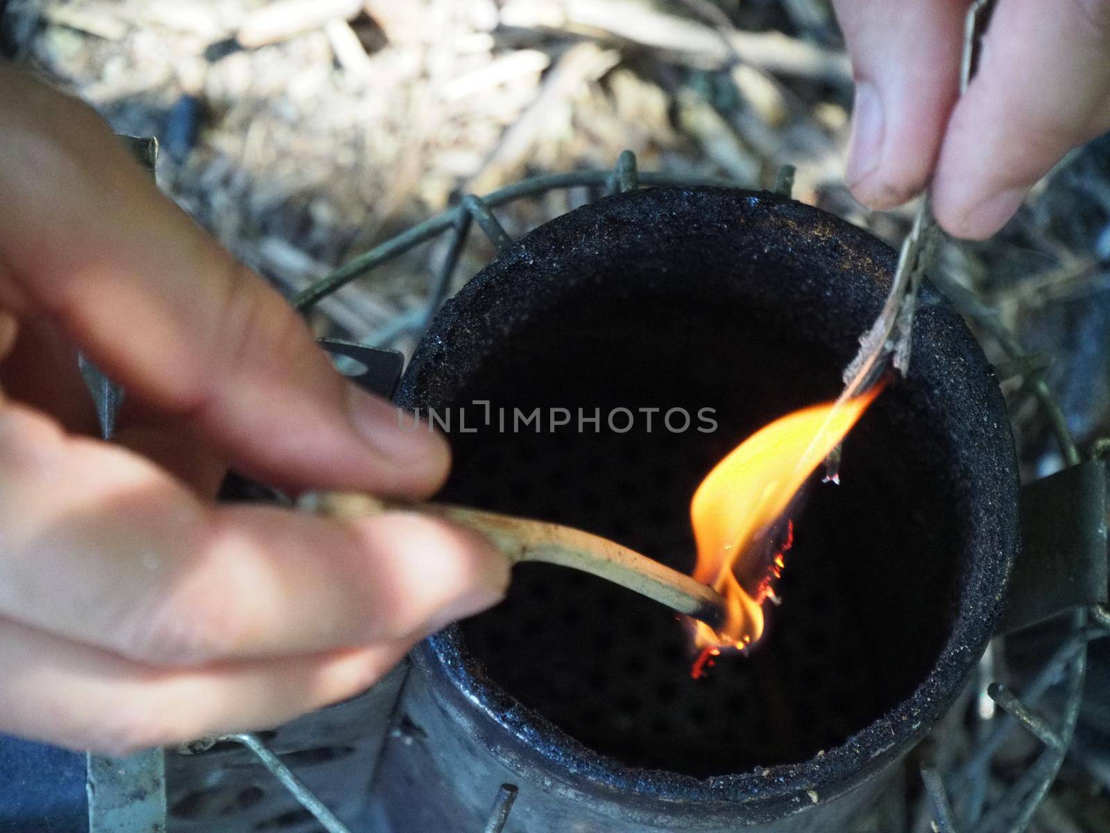 starting a bee smoker before harvesting honey hives in the farm.