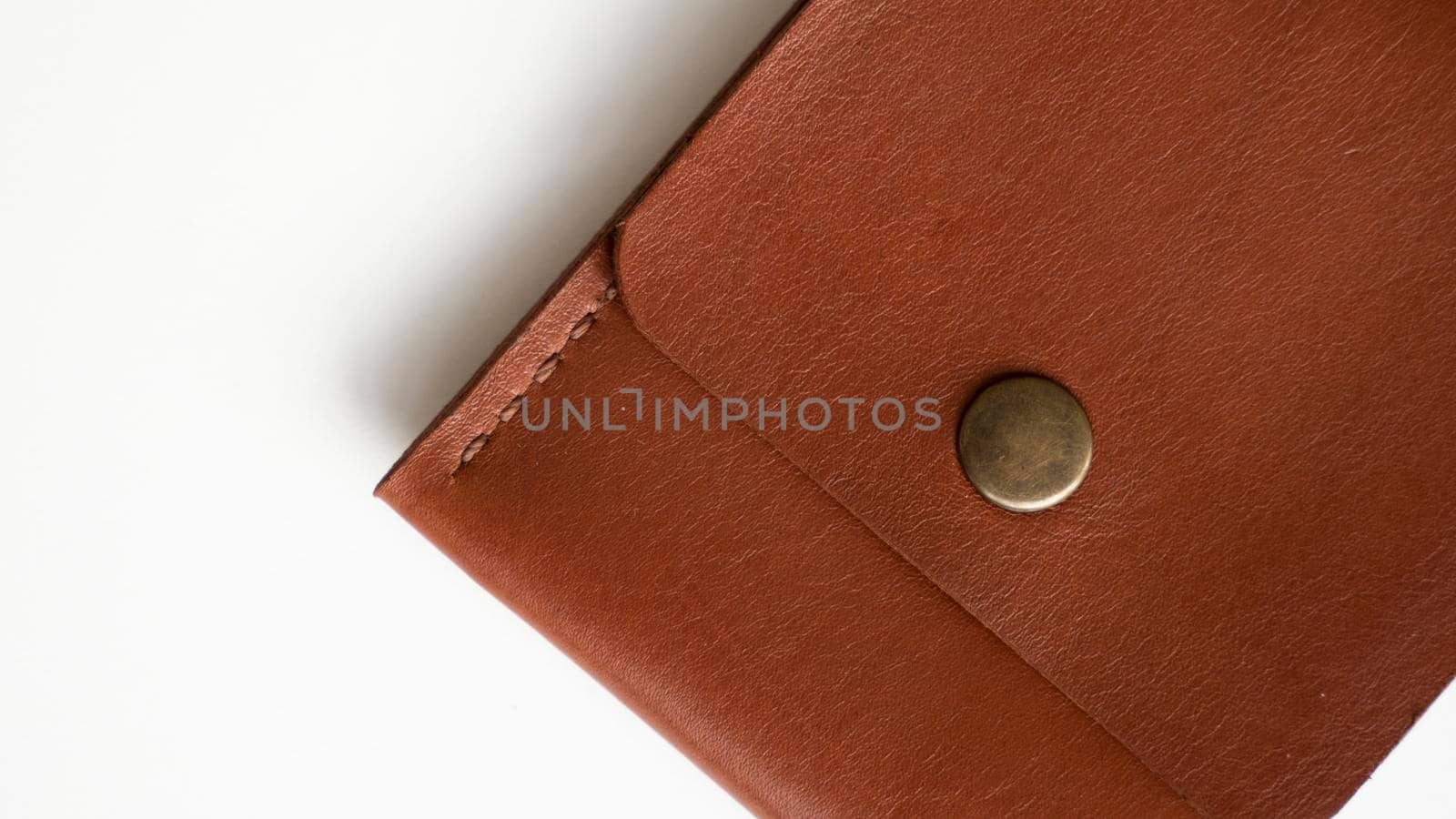 Orange genuine leather card holder on a white surface. by vovsht