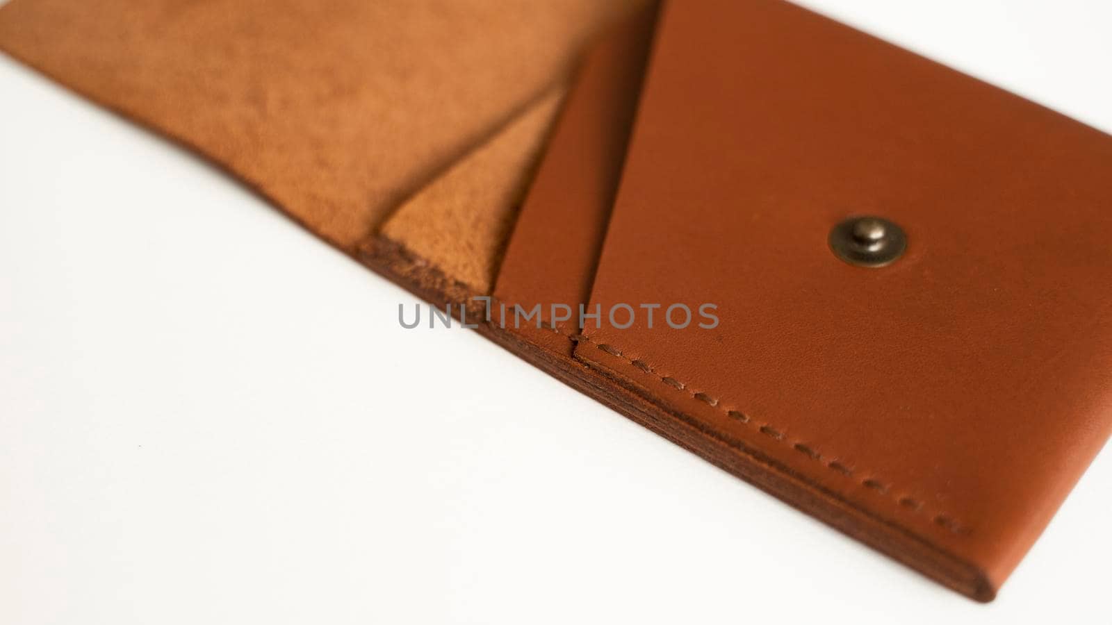 Opened empty orange genuine leather card holder on a white surface. by vovsht
