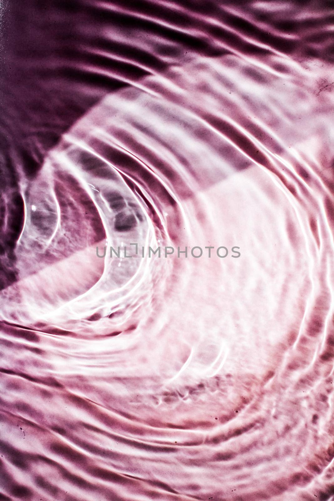 Pink flowing water texture as an abstract background - colourful liquids and creative designs concept. Pink flow