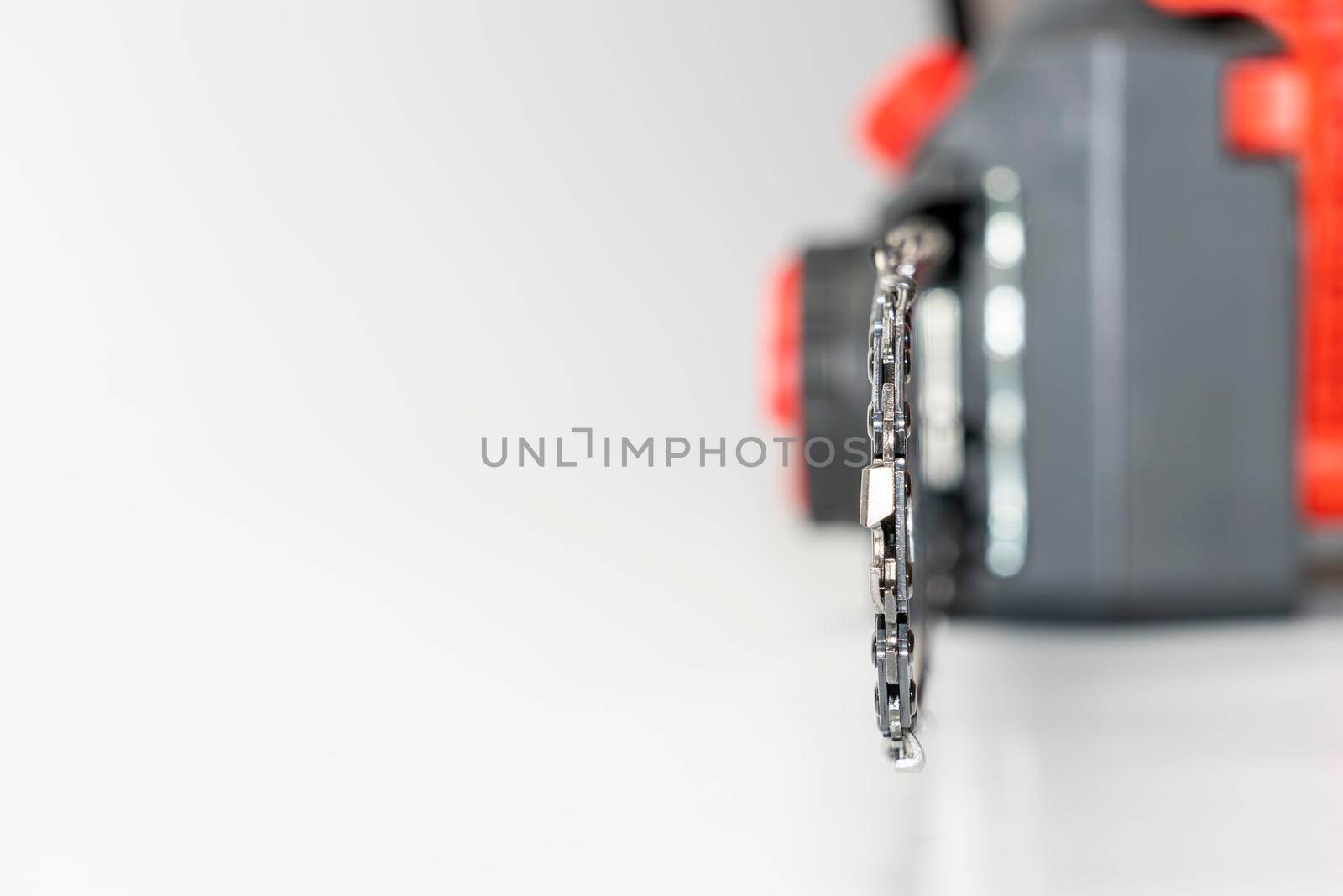 Chain saw on wood on a white background. High quality photo