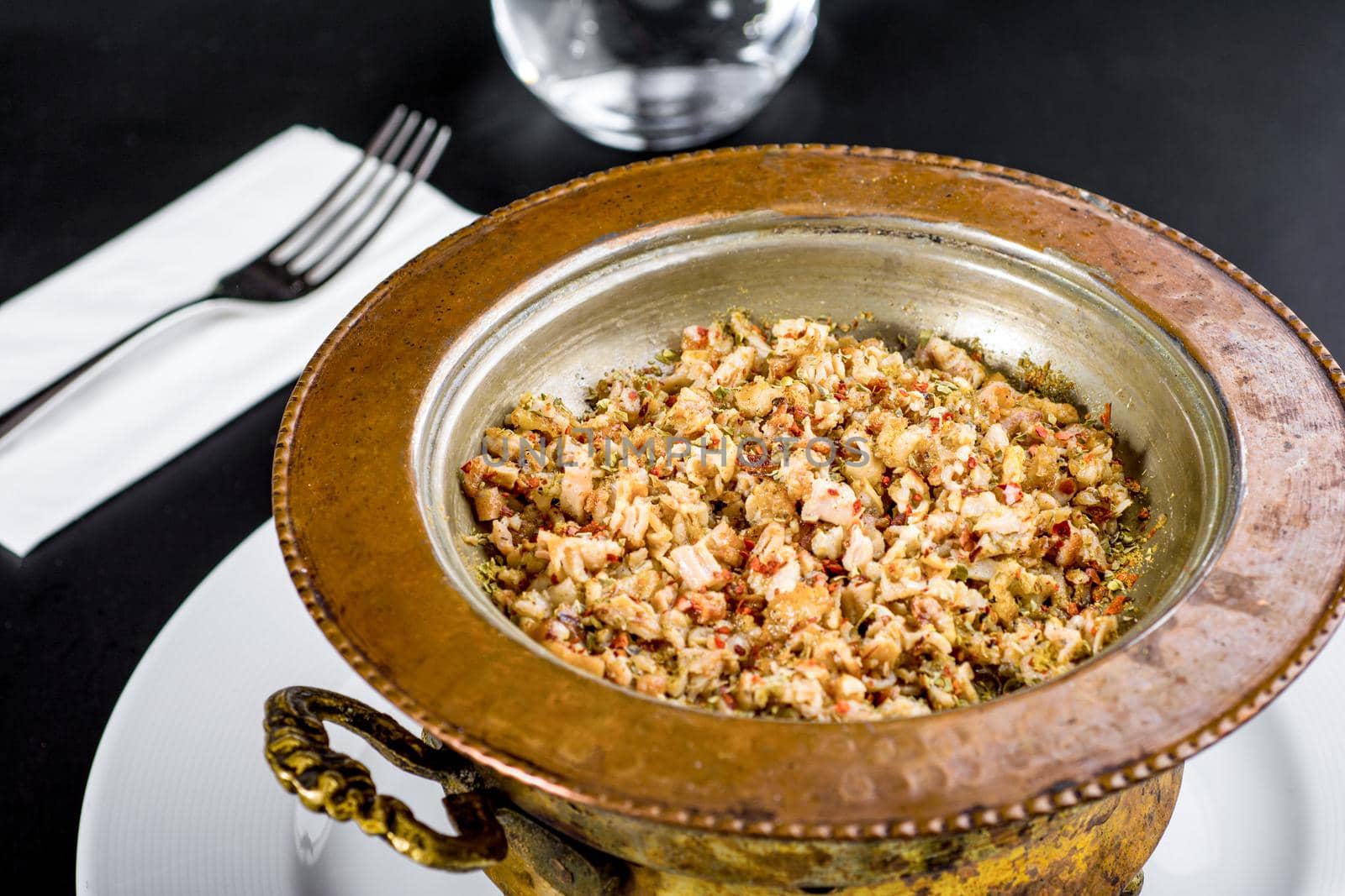 Spicy minced lamb kokorec in a copper skillet.