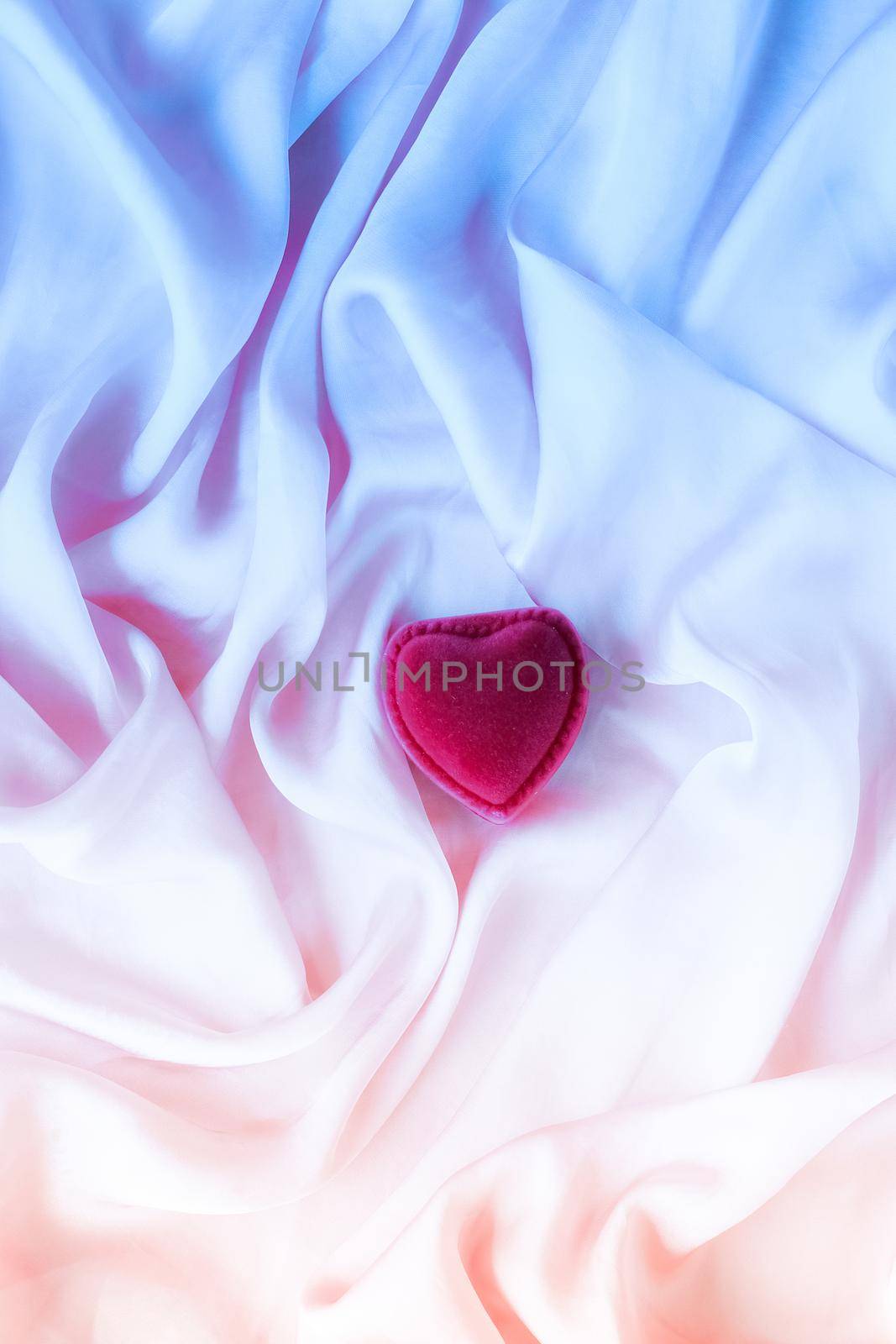 Valentine's day, true love, engagement and proposal concept - Heart-shaped gift box on neon silk. Will you be my Valentine?