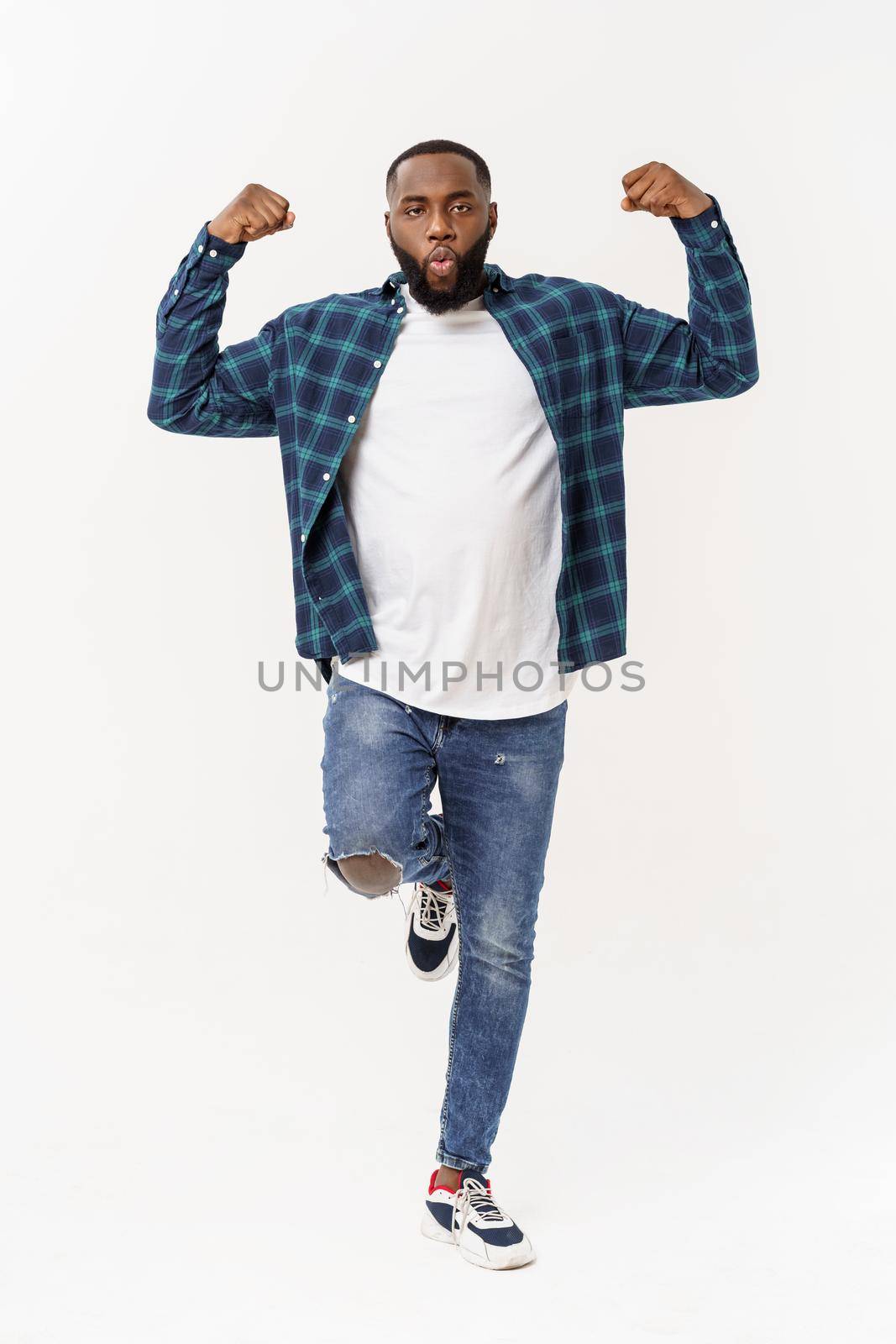 Healthy young black man jogging. Isolated over white background. by Benzoix