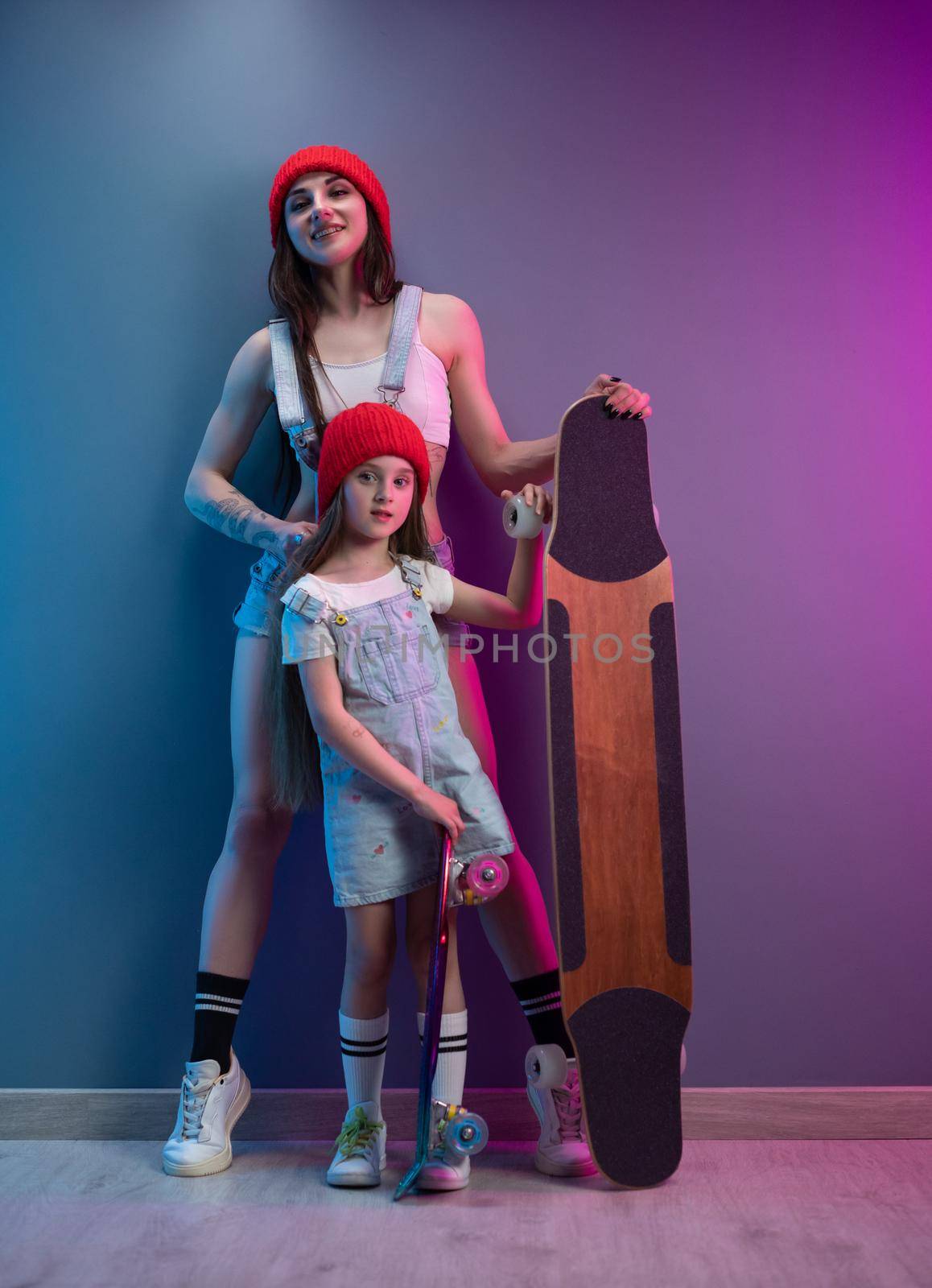 a young mother with her daughter on a skateboard and a longboard by Rotozey