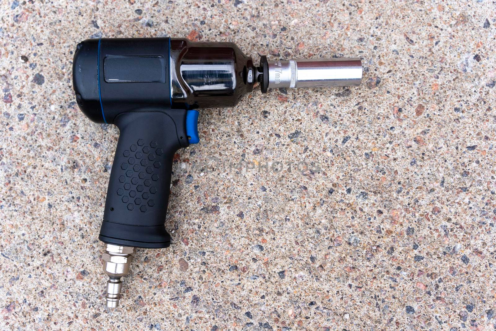 a pneumatic impact wrench with an end head on the concrete floor by audiznam2609