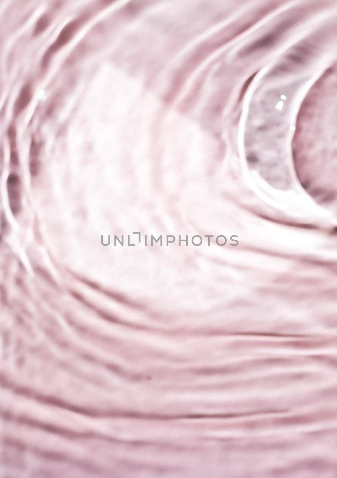 Pink flowing water texture as an abstract background - colourful liquids and creative designs concept. Pink flow