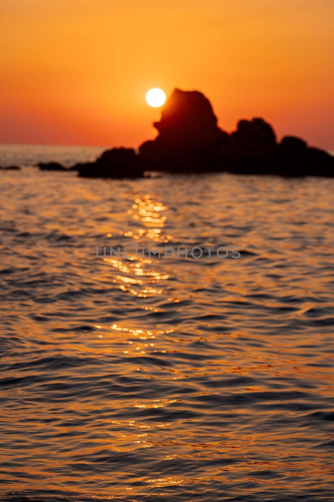 Beautiful view of orange sunset seascape with rocks in Italy. Tropical colourful sunrise landscape. Nature landscape. Tropical coast by photolime