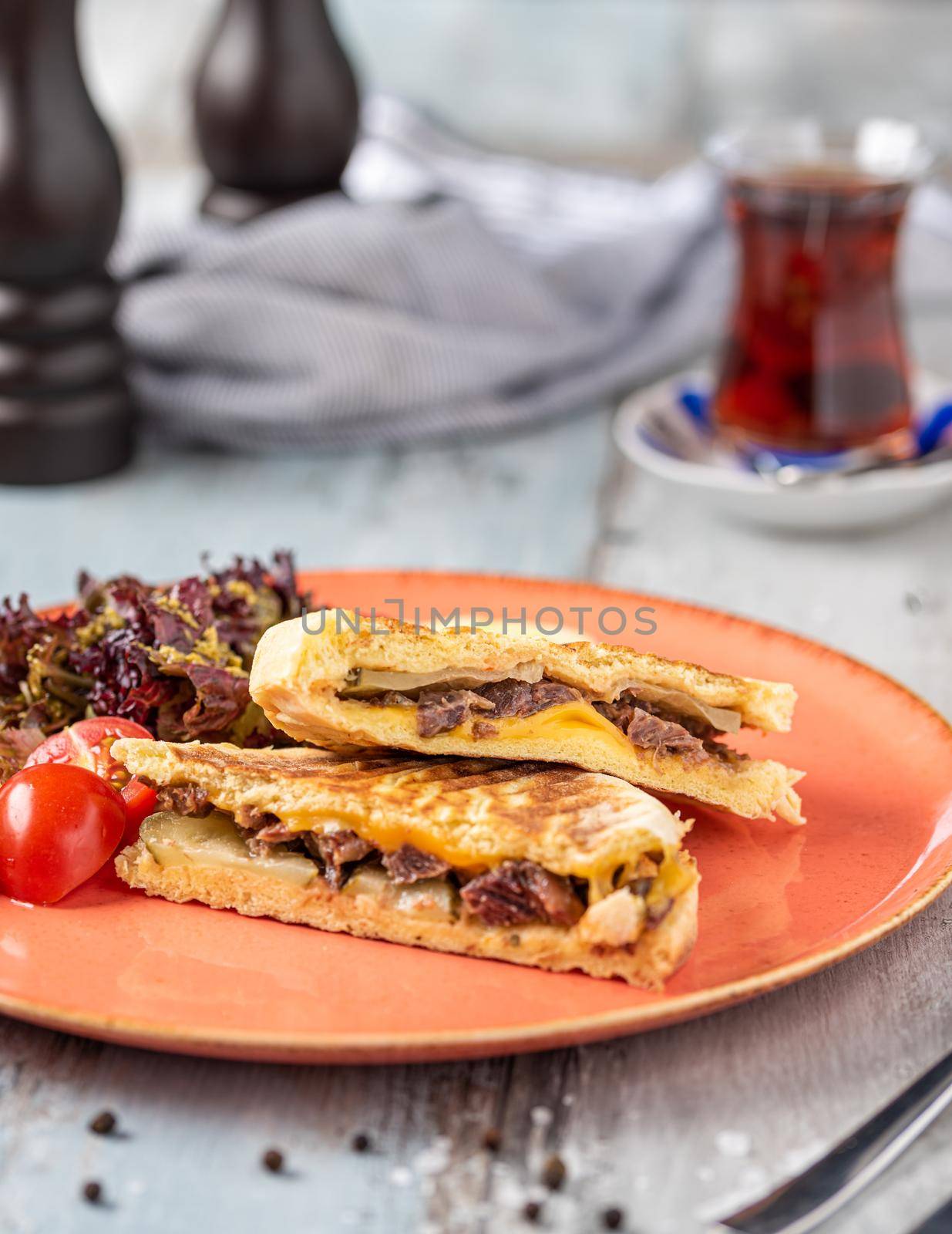 Turkish toast with roasted meat served with turkish black tea