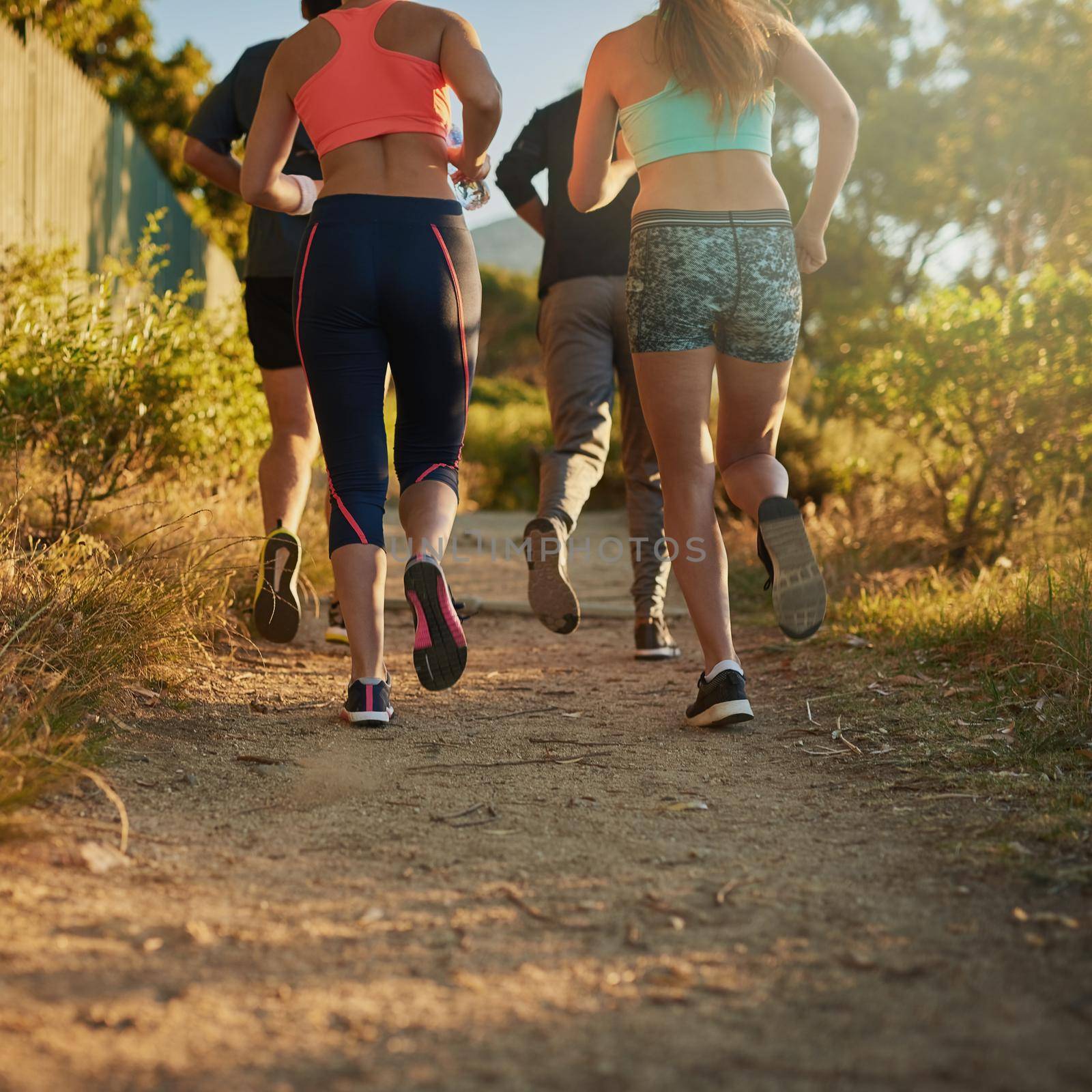 Workout pals give you the boost you need. a fitness group out running. by YuriArcurs