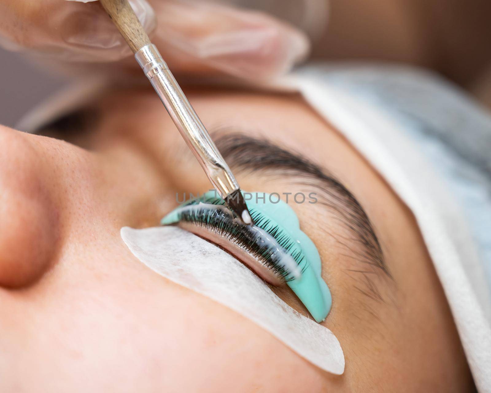 Close-up portrait of a woman on eyelash lamination procedure. by mrwed54