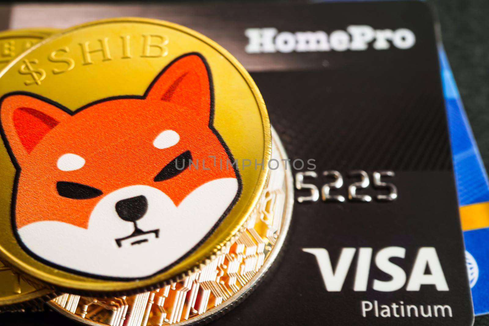 Bangkok, Thailand - December 15, 2021 Golden bitcoin with credit card on US dollar banknotes money for business and commercial, Digital currency, Virtual cryptocurrency.