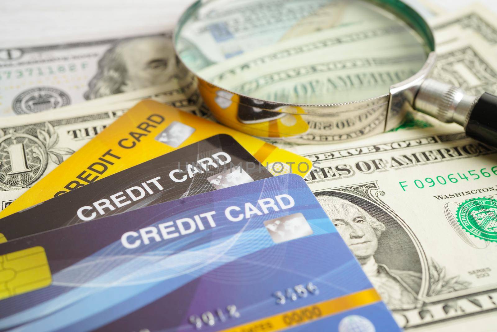 Credit card and magnifying glass for online shopping, security finance business concept.