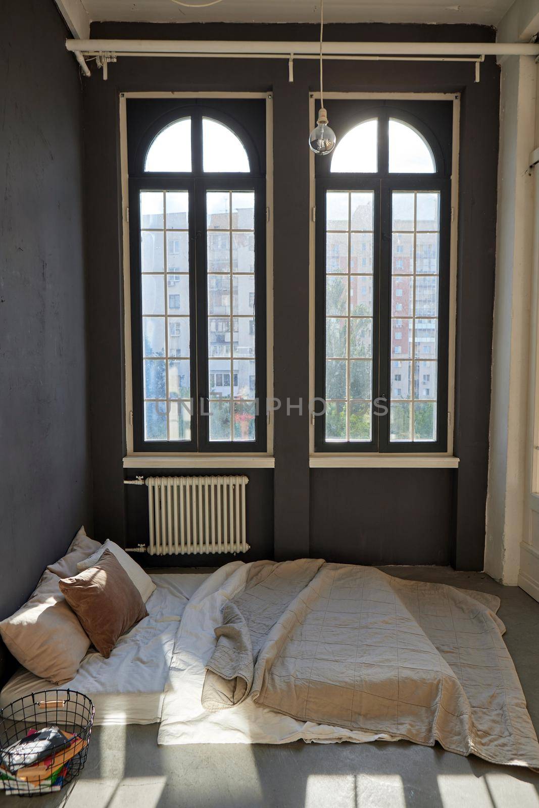 Interior of sunlit bedroom at home in dark room by Demkat