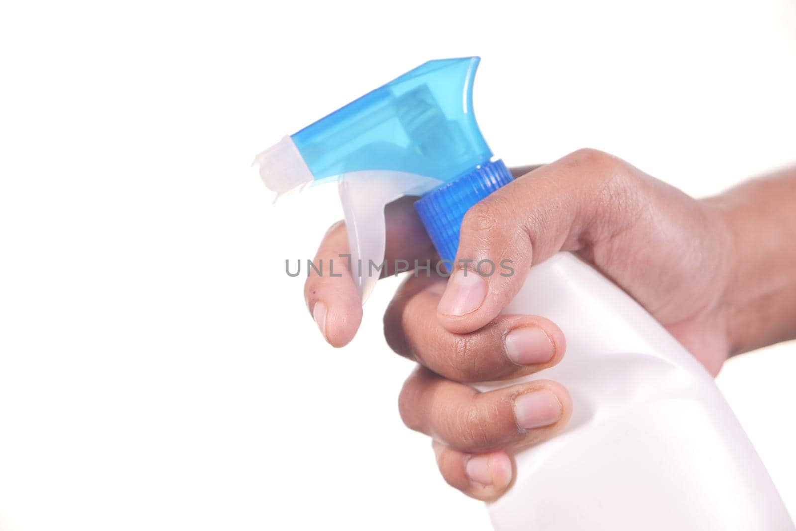 hand holding spray bottle isolated in white .