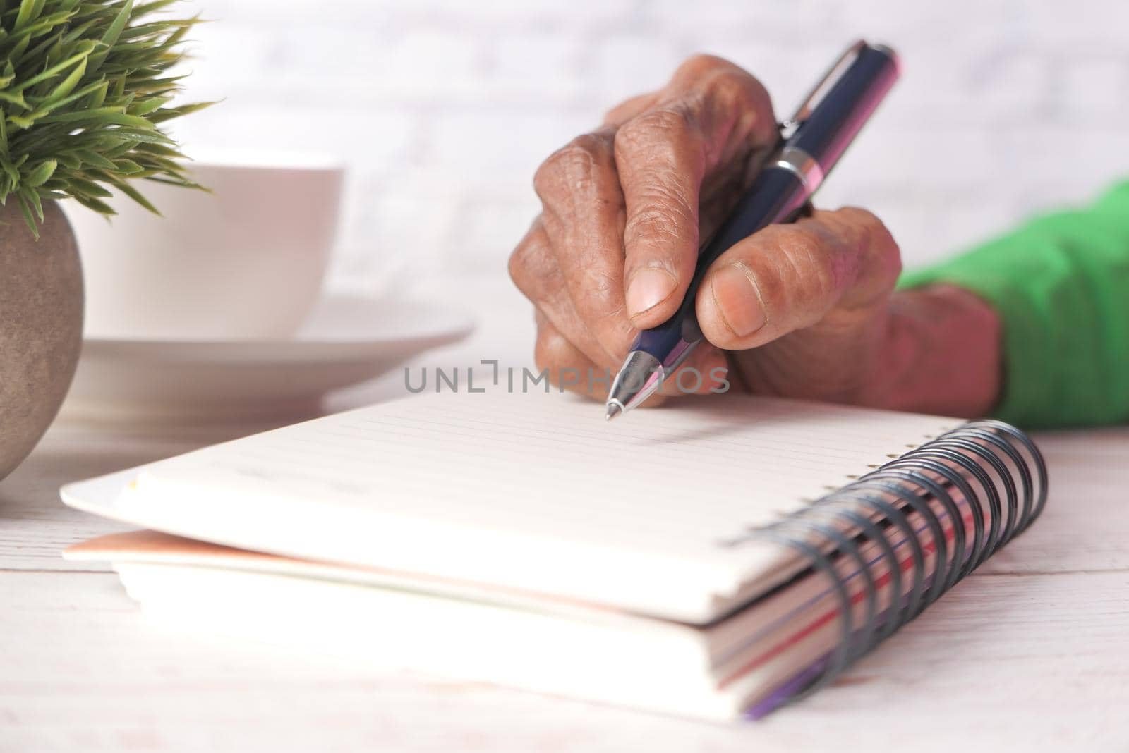 Close up of senior women hand writing on notepad