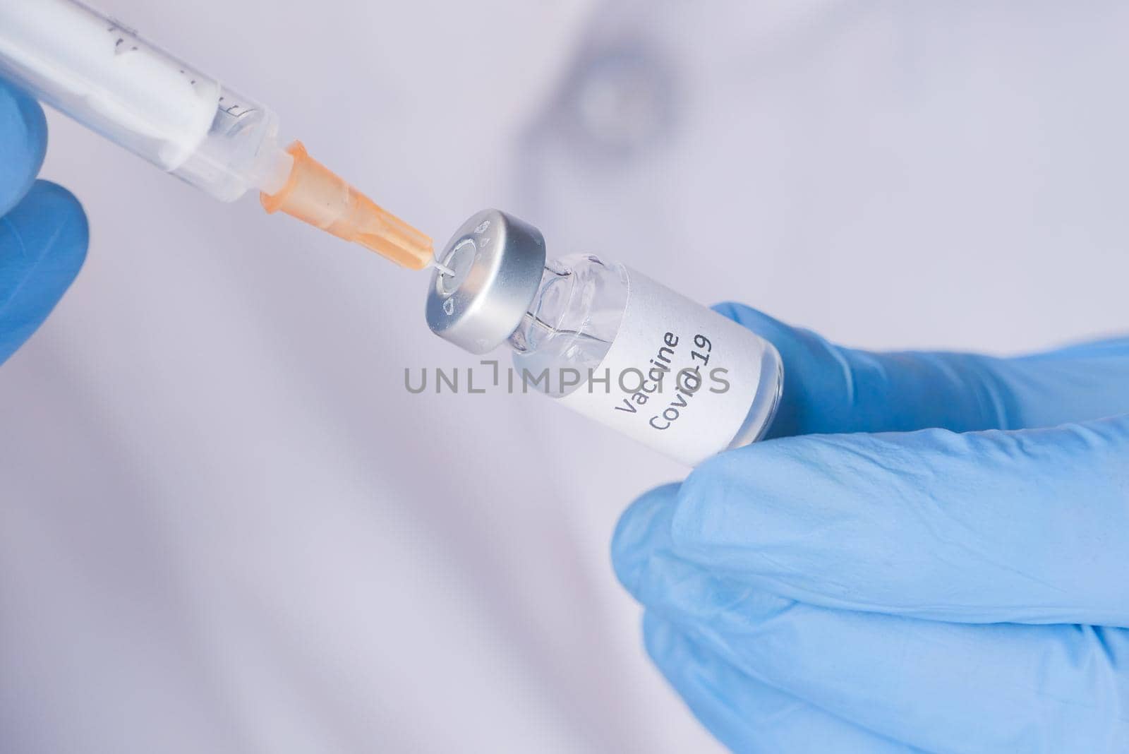 Doctor hands in medical gloves holds syringe and vaccine