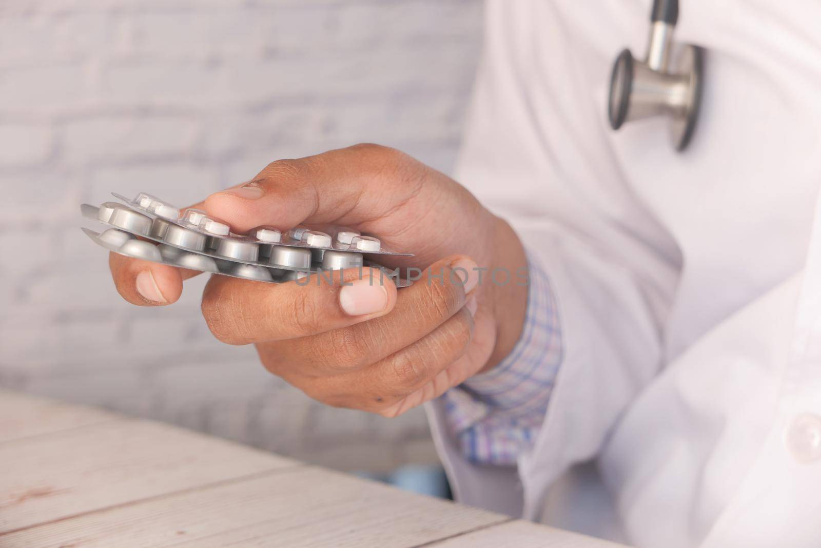 Close up of man holding blister packs