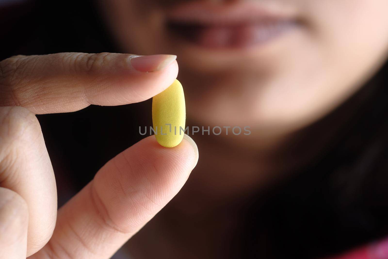 young women hand holding pills close up .