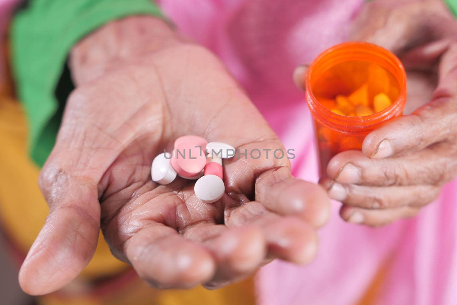senior women hand's taking medicine, close up .