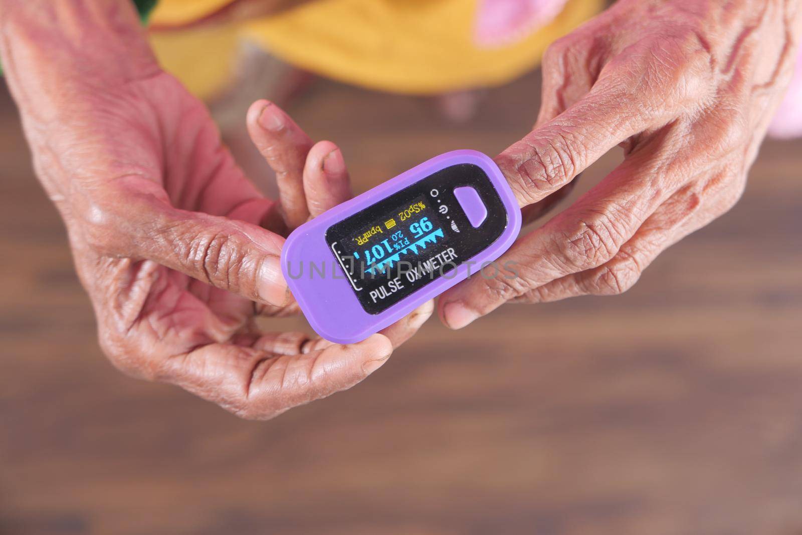 senior women hand using pulse oximeter.