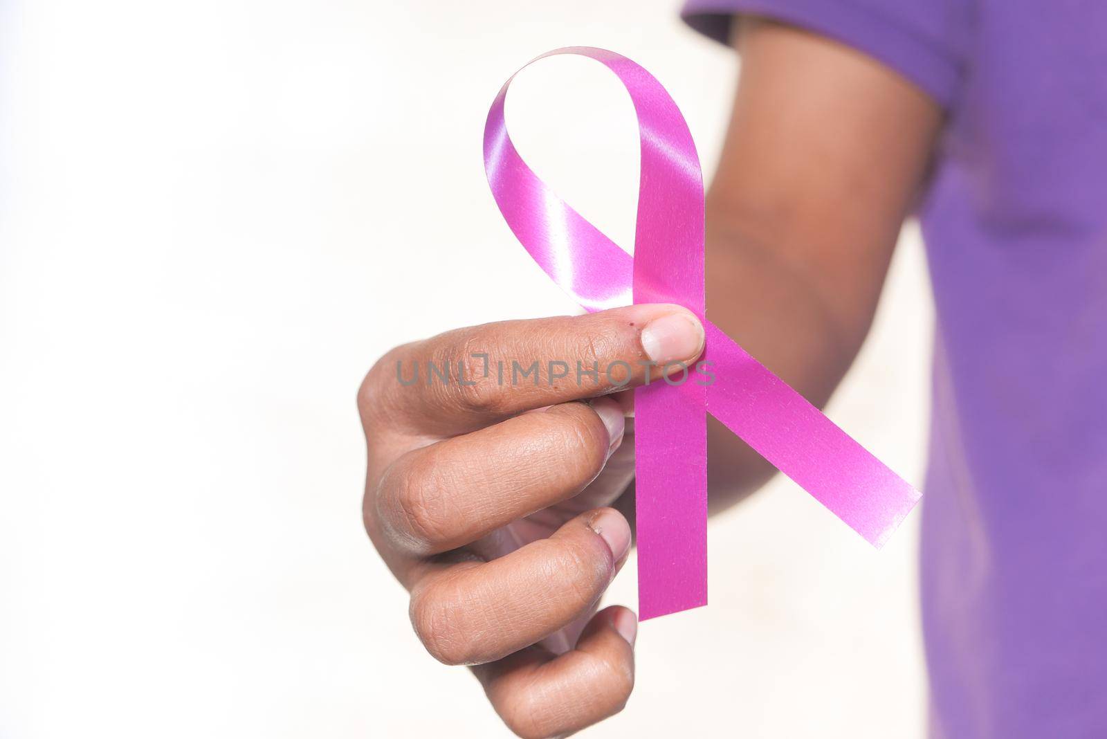 hand holding HIV ribbon close up ,