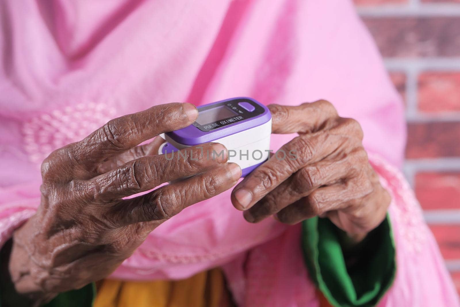 senior women hand using pulse oximeter.