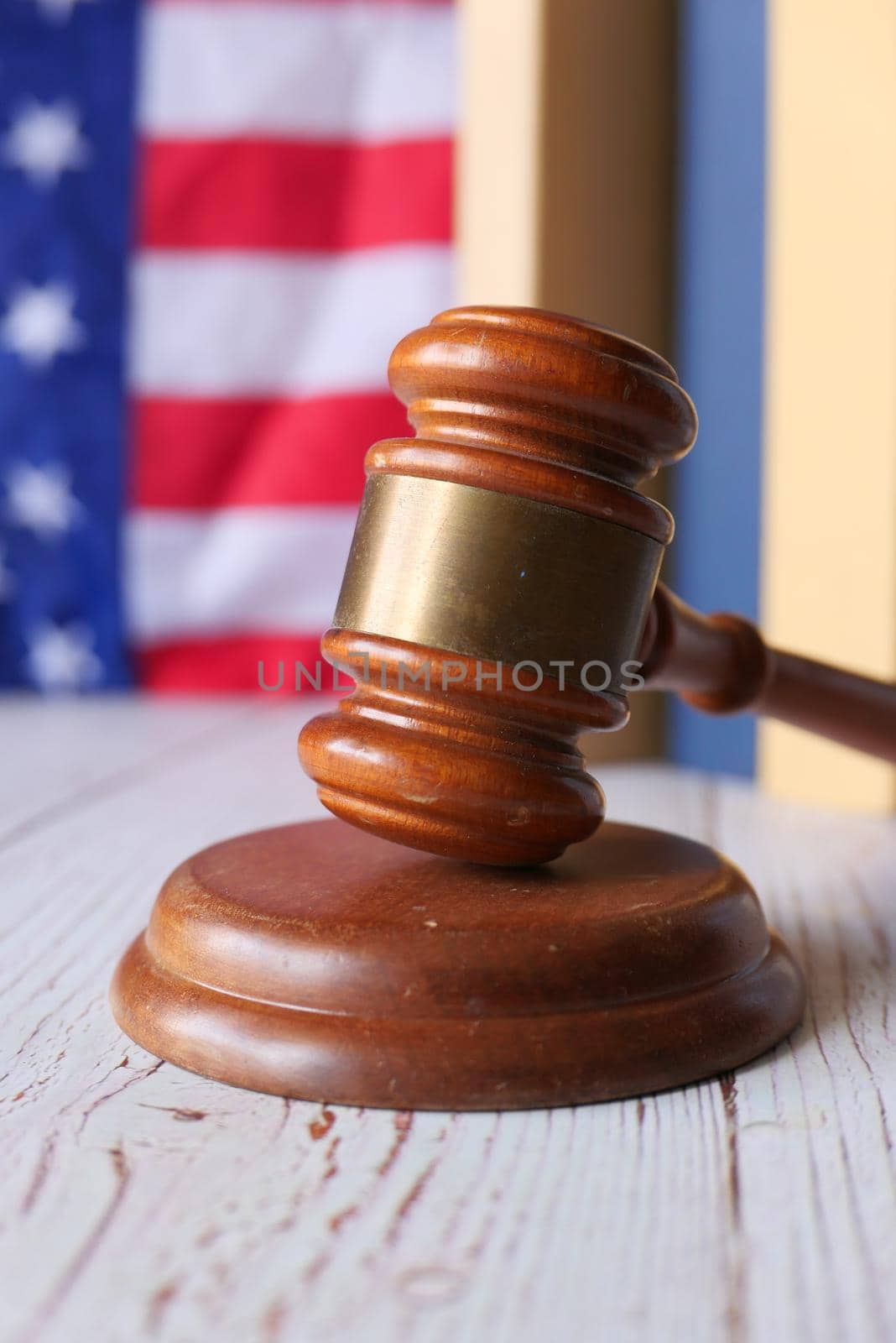selective focus. Closeup of gavel and book against american flag .