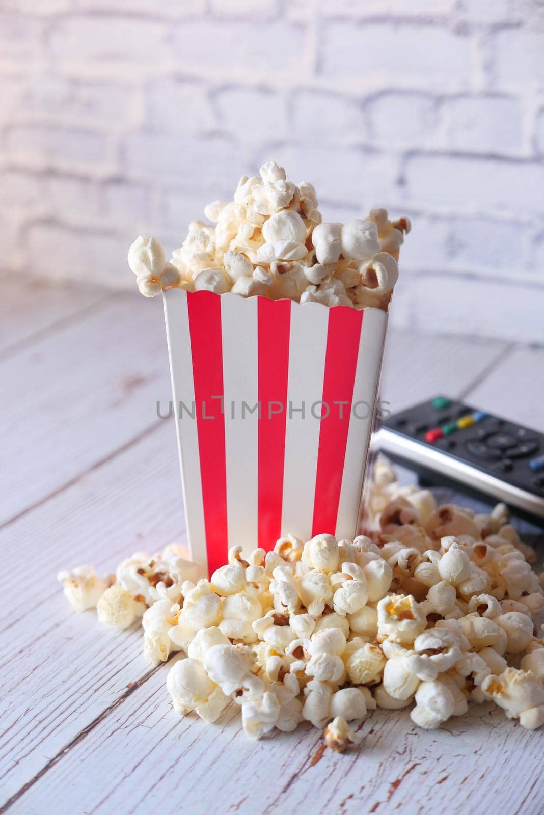 high angle view of popcorn spilling from container .