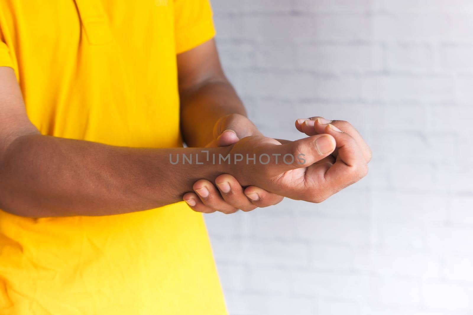 man suffering pain in hand close up .