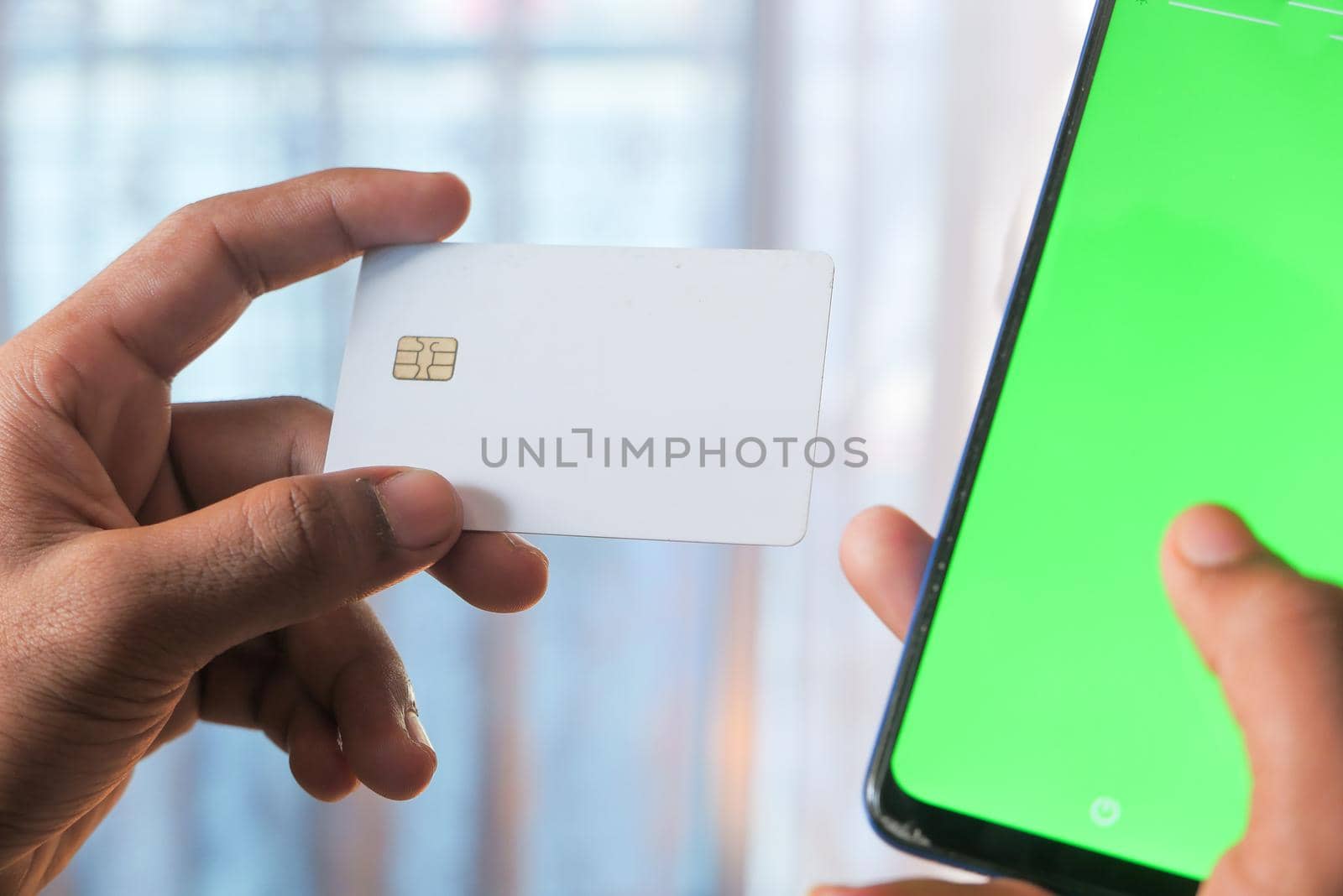 Man hand holding credit card and using smart phone shopping online .