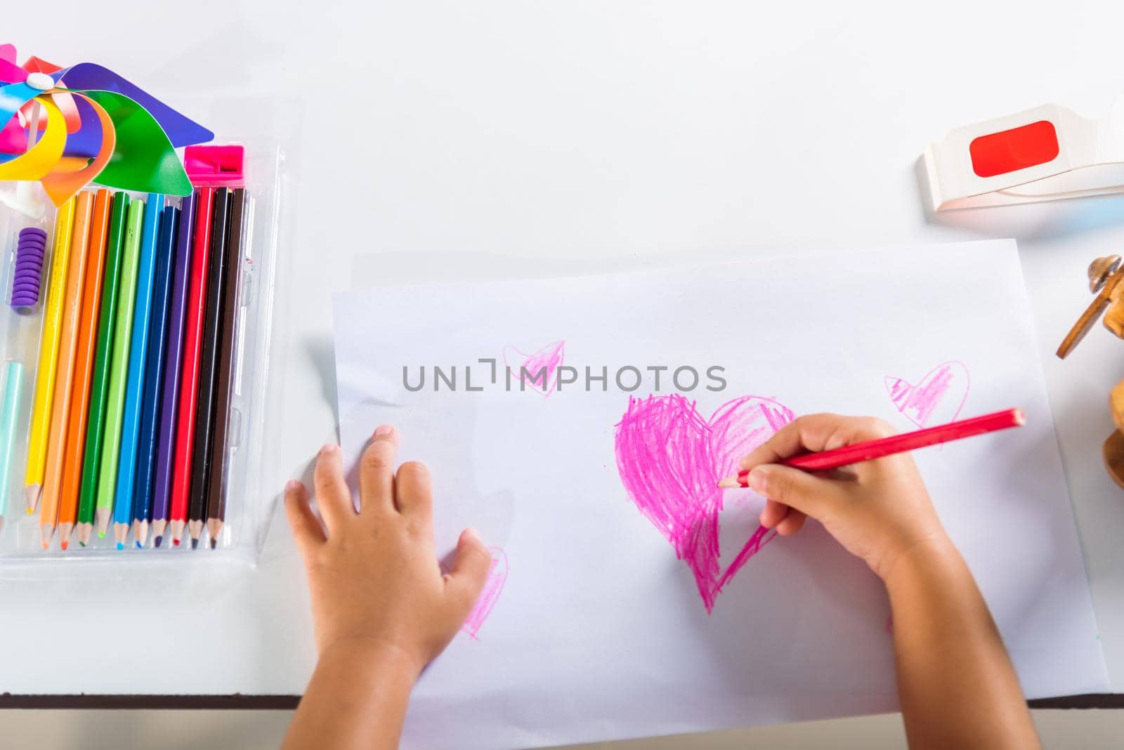 Asian cute kid preschool smiling draw creative hearts love picture at home, Happy child little girl colorful drawing pink heart on white paper, Valentine day or Mother or Fathers Day, art education