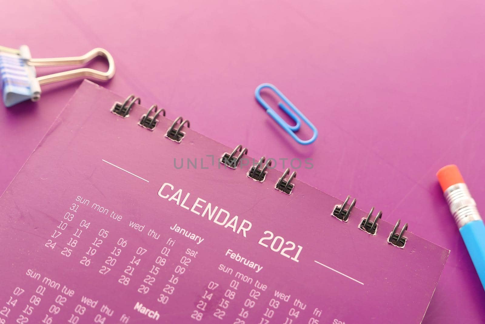new year goals concept with 2021 calendar on color background .
